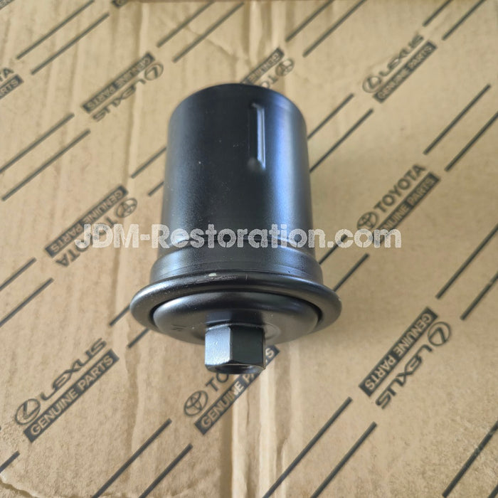 Black mechanical part on a cardboard background with Toyota and Lexus branding.