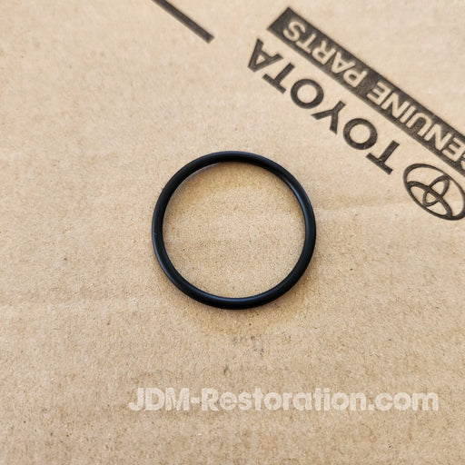 Black rubber ring on a cardboard background with Toyota branding