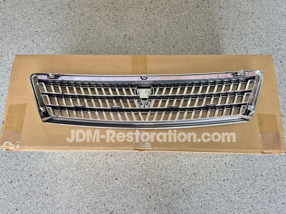 Car grille on a cardboard box with 'JDM-Restoration.com' branding.