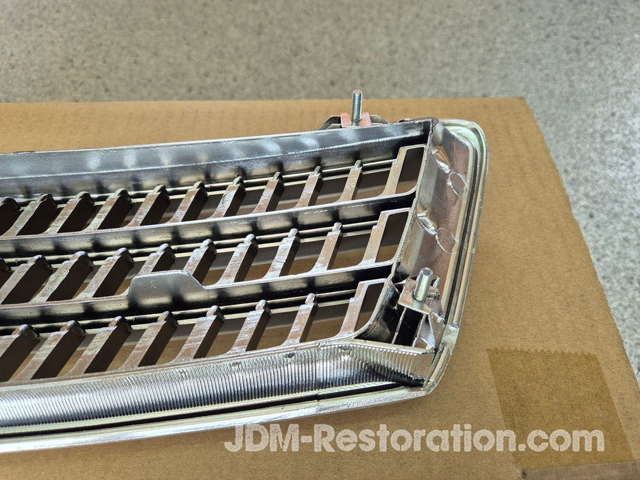 Metal car grille on a cardboard box with 'JDM-Restoration.com' branding.