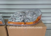 Car headlights on a cardboard box with 'JDM-Restoration.com' branding.