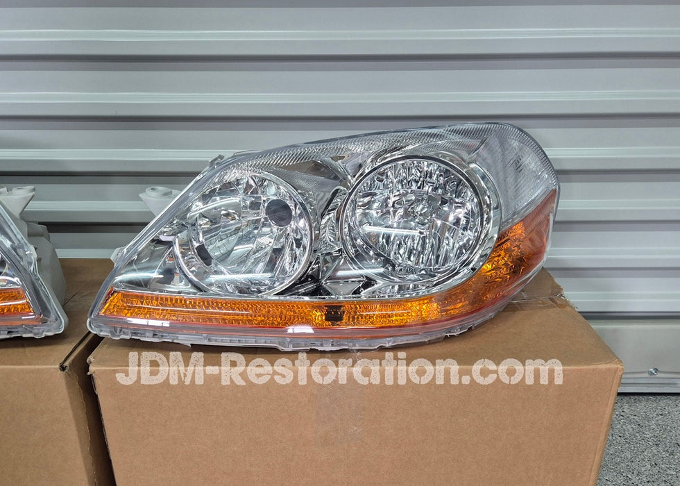 Car headlights on a cardboard box with 'JDM-Restoration.com' branding.