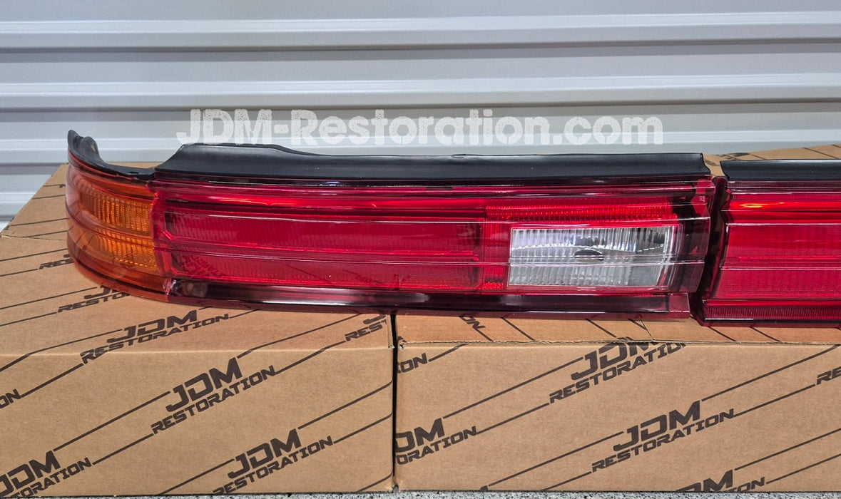 Car tail light on a cardboard box with JDM Restoration branding.
