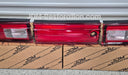 Red car tail lights on cardboard boxes with 'JDM Restoration' branding.