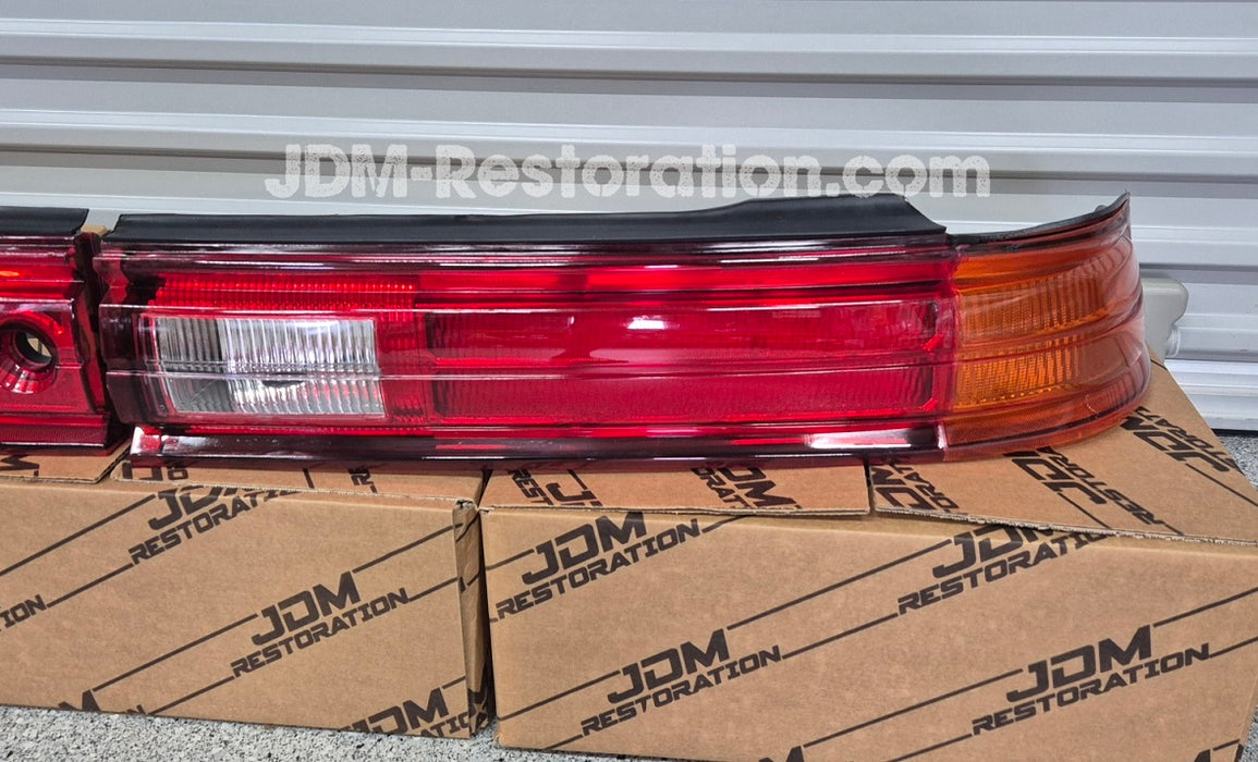 Car tail light assembly on a cardboard box with 'JDM Restoration' branding.