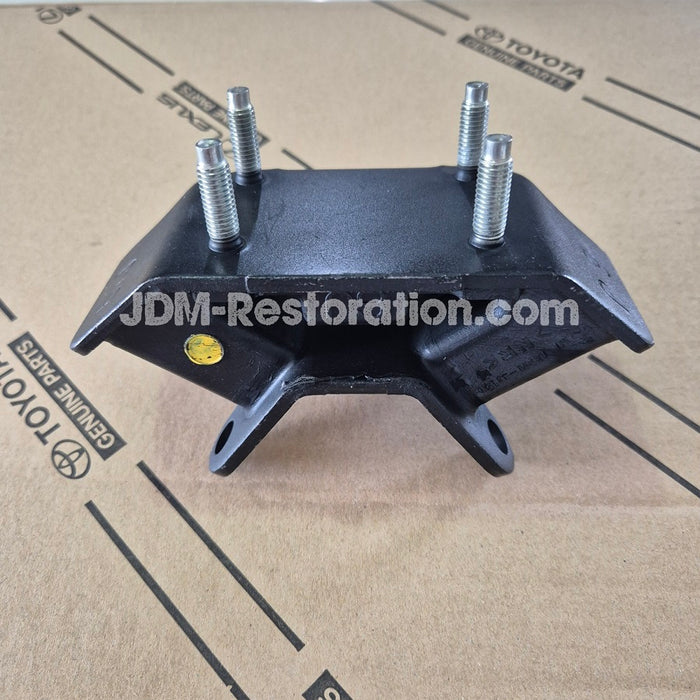 Black metal component with screws on a cardboard surface with 'JDM-Restoration.com' branding.