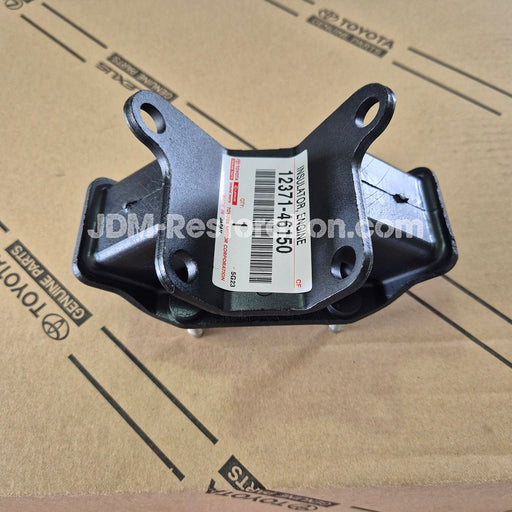 Black automotive part with a label on a cardboard background
