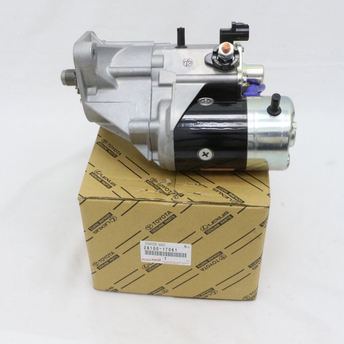 A Toyota starter motor assembly resting on its original branded cardboard box, photographed against a plain white background.