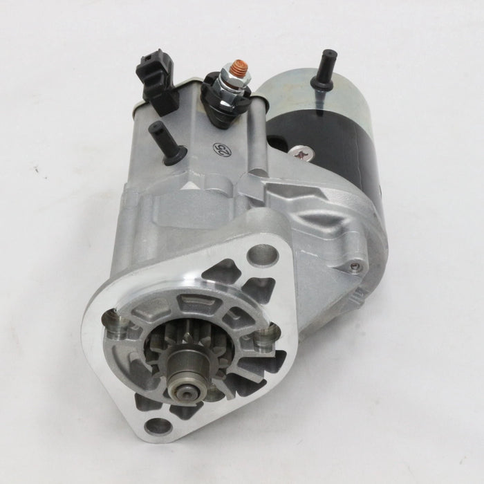 A Toyota starter motor assembly resting on its original branded cardboard box, photographed against a plain white background.