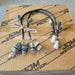 A wiring harness kit with multiple black braided wires, plastic connectors, and small bulbs, laid out on top of a brown cardboard box printed with JDM Restoration branding.