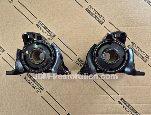 Two black automotive parts on a cardboard background with Toyota branding.